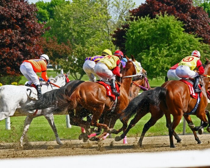 Dynamic horse racing scene with jockeys and vibrant nature backdrop.