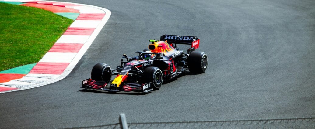 High-speed Formula One car racing at a circuit in Mexico City.