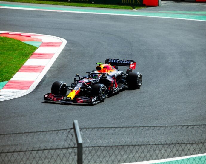 High-speed Formula One car racing at a circuit in Mexico City.