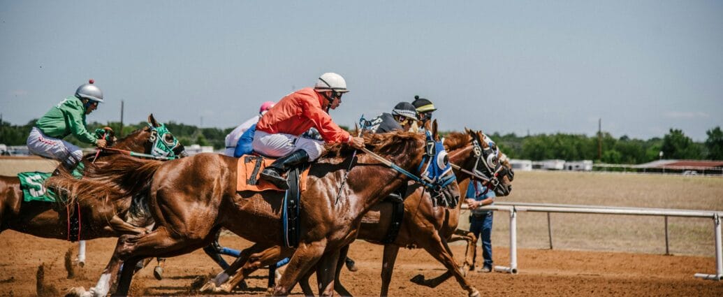 Dynamic horse race capturing several jockeys competing on a clear day.