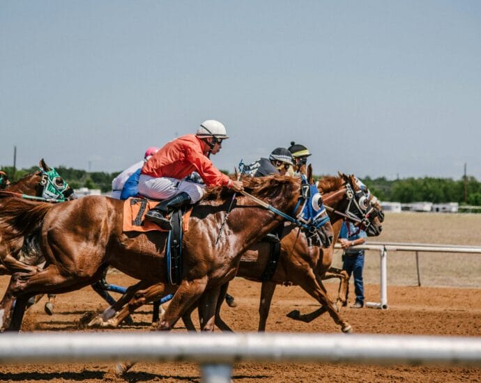 Dynamic horse race capturing several jockeys competing on a clear day.