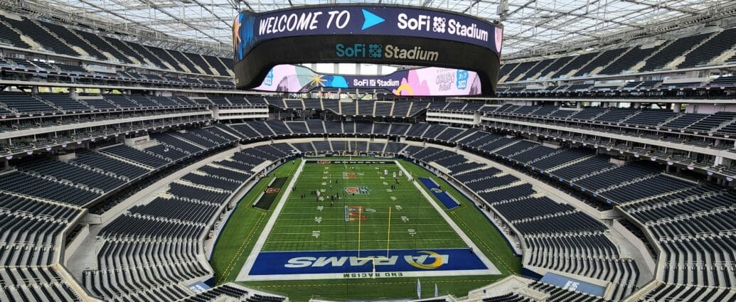 Aerial view of SoFi Stadium in Los Angeles with empty seats and sports field.