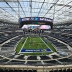 Aerial view of SoFi Stadium in Los Angeles with empty seats and sports field.