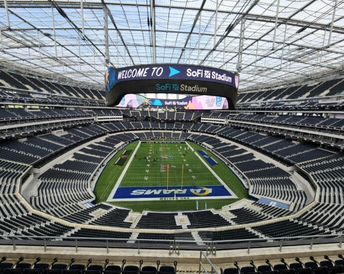 Aerial view of SoFi Stadium in Los Angeles with empty seats and sports field.