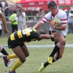 Action-packed rugby scene capturing a dramatic tackle during a competitive match.