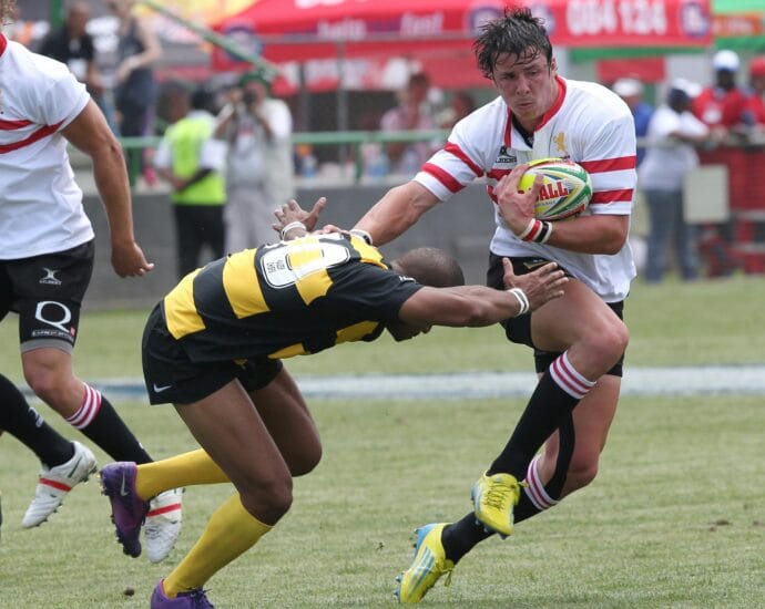 Action-packed rugby scene capturing a dramatic tackle during a competitive match.