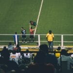Soccer player substitution during a match at a stadium with an engaged audience.