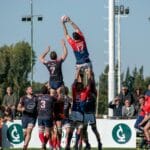 Rugby players competing midair in a dynamic outdoor match in Buenos Aires, Argentina.