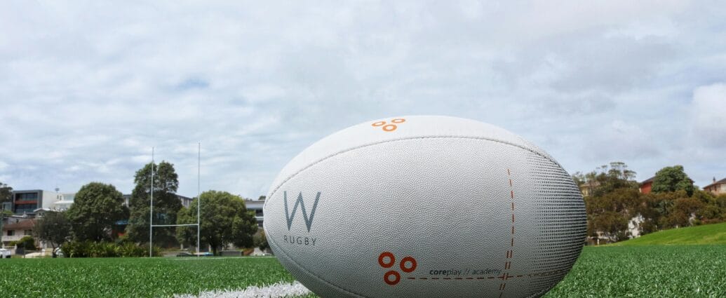 A detailed shot of a rugby ball on a green sports field, perfect for sports equipment themes.