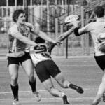 Dynamic black and white photo of rugby players in action during an intense match on the field.