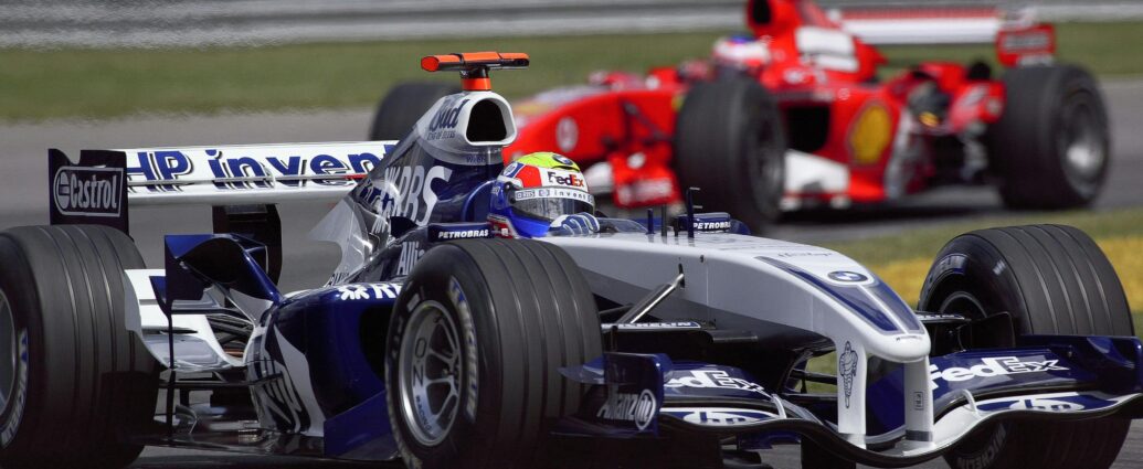 Close-up of two Formula 1 cars racing at high speed during a championship event.