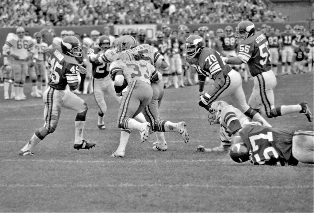 A vintage capture of athletes competing in a high-energy football game.